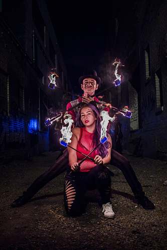 leisure activities woman and man holding stick with fire during night time human